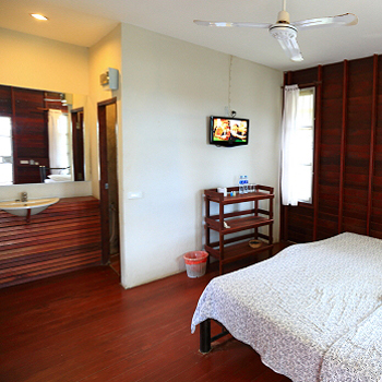 Cozy fan-type hut at Tubtim Resort surrounded by tropical greenery