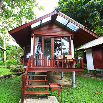 Tubtim Resort at night with softly lit air-conditioned huts by the shore