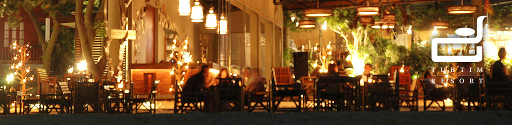 Open-air restaurant glowing with warm night lights